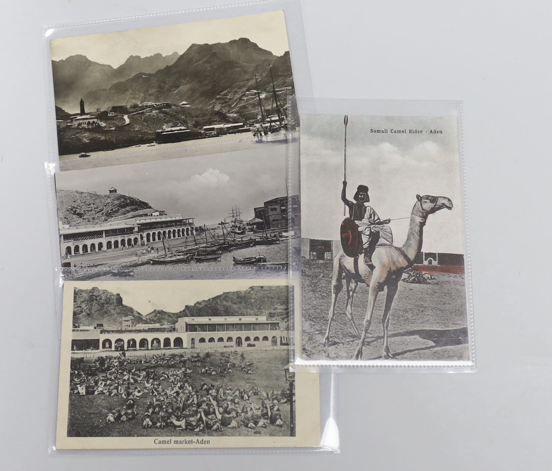 Three enamel 1930s Cresta Run, St. Moritz ice racing toboggan track lapel badges and a Bobsleigh Challenge Cup badge, together with a collection of 46 Aden related postcards from the early 20th century